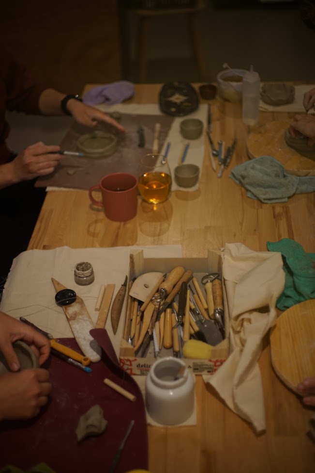 Participants focused on their ceramic pieces during the session