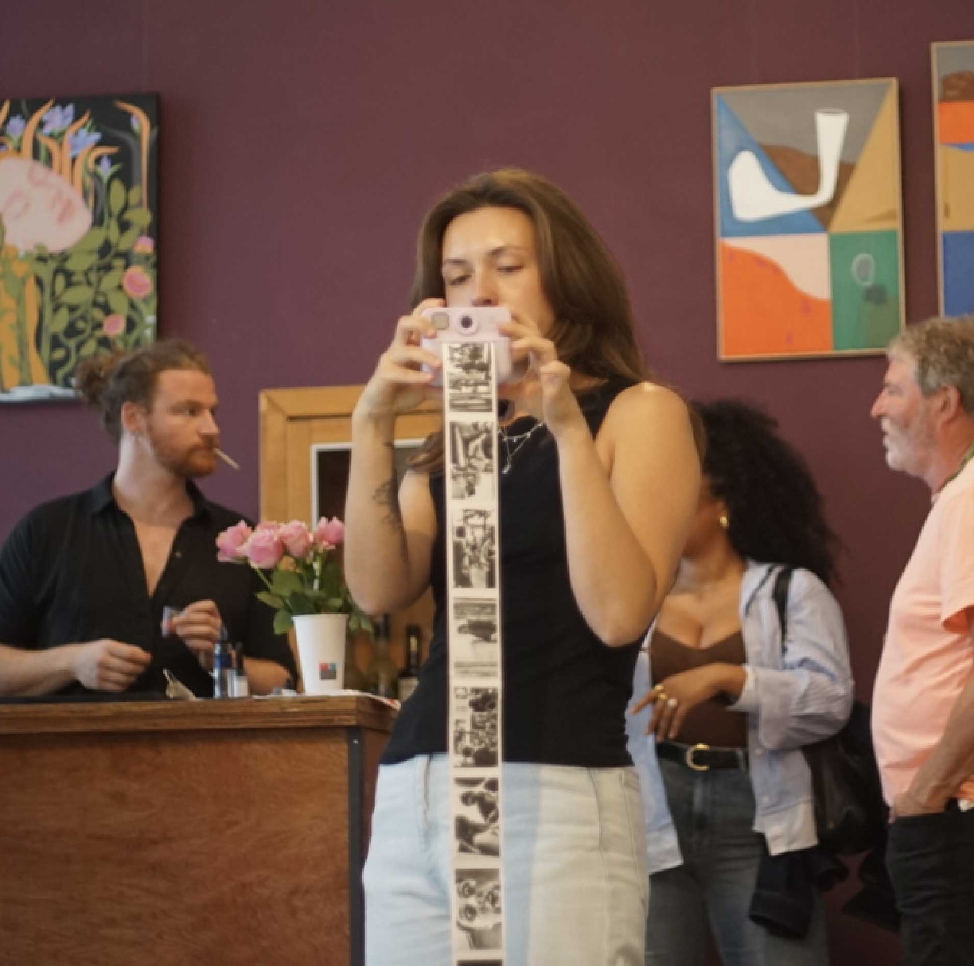 A guest shooting a photobooth filmstrip at a studio event