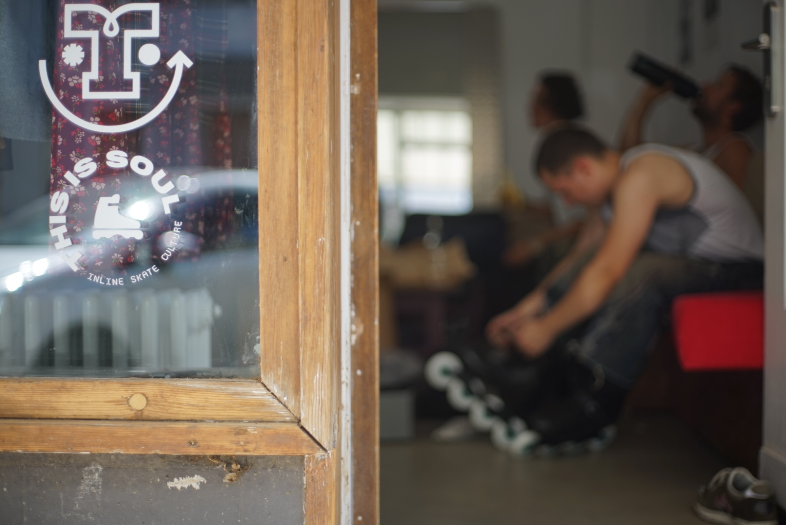 The thisissoul decal on the studio's front window, with the showroom visible behind it